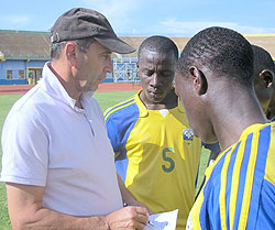 Richard Tardy (L) talks to his players after a training session. (File Photo)