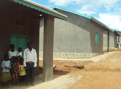 Esperance Nyirabambogo poses with the husband Kalisa Emmanuel at their house with the children. Photo G. Mugoya