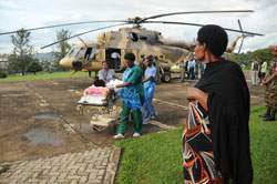 A relative of one of the Tanzanian road accident victim watches as the RDF air rescue team transfer patients to King Faisal Hospital, yesterday. (Photo J Mbanda)