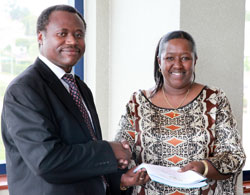 New Health Minister Agnes Binagwaho (R) hands over to the new Permanent Secretary in the Ministry Uziel Ndagijimana yesterday. (T Kisambira).