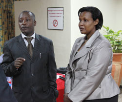 Ms Odda Gasinzigwa, chief of gender monitoring chats with Jules S.Makuza, a consultant in gender Monitoring (Photo T.Kisambira)