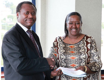 Health Minister Agnes Binagwaho (R) handing over to the new Permanent Secretary in the Ministry Uziel Ndagijimana on Friday. (T Kisambira)