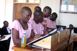 Ingabire (L) with her co-accused in court yesterday. (Courtsey Photo).