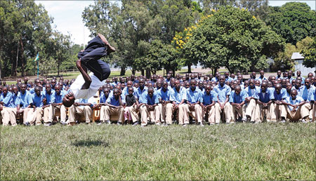A Karate student shows Parents and his fellow students some of his acrobatic skills during the graduation ceremony