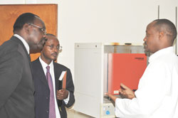 The Minister of Commerce, Francois Kanimba (Left) with Mark Cyubahiro and are taken around the RBS headquarters by a technician (Photo; E. Kabeera)