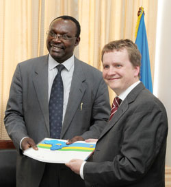 Nils Warmer hands over the Atlas to the Minister of Commerce, Francois Kanimba (Photo; T. Kisambira)
