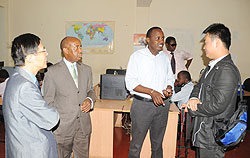 The New Times Managing Editor, Collin Haba (2n R) speaks to Liang, head of Xinhua office in Kigali, as the Managing Director of The New Times, Joseph Bideri and Ambassador Shu Zhan look on (Photo; J. Mbanda) 