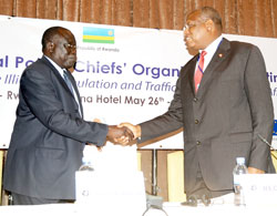 Justice Minister Tharcise Karugarama (L) shakes hands with RECSA boss Francis Sang before offically closing the Police chiefs meeting yesterday (Photo; J. Mbanda)