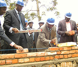 Western Province Governor Celestin Kabahizi (Second Right) lays a foundation stone in the company of Youth Minister Hon. Protais Mitali (L) (Photo; S. Nkurunziza)