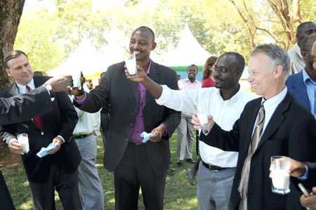 US Ambassador W. Stuart Symington (L), Ernest Ruzindaza (C) and other officials make a toast at the launch yesterday (Photo; J. Mbanda)
