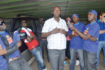 Methode Muyombana, the Assistant Administrator of Bralirwa, explains to the artistes the history of Bralirwa Gisenyi plant.