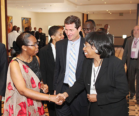 One of the participants, Bernice Donald (L) , talks to Chief Justice Cyanzayire as Stephen Gardner from the Commercial Law Development Programme (USA) looks on. (Photo T.Kisambira)