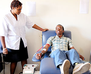 Nshimiyumuremyi Marie Vianney donates blood at NCBT. (Photo T.Kisambira)
