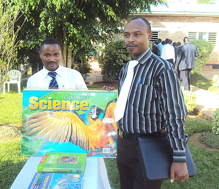 Martin Rutazirwa (L) display the books. Photo S. Rwembeho