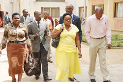 Parliamentarians take a break during discussions on family planning, yesterday. (Photo J Mbanda