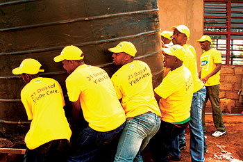 MTN staff assisting with installation of the  water tank at Sovu Secondary School. Photo S Rwembeho