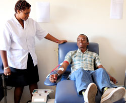 Nshimiyumuremyi Marie Vianney donates blood at CHUK. Several Rwandans donated blood during the just concluded blood donation week (File Photo )