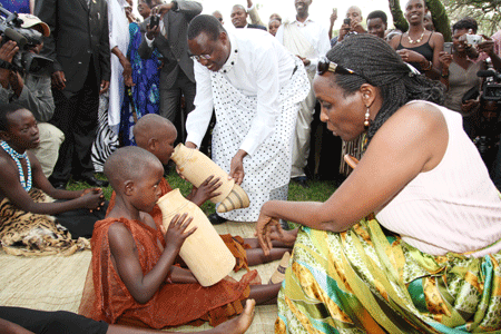 Agriculture Minister, Dr Agnes Kalibata,  and Minister of Sports, Youth and Culture Protais  Mitali give milk to children during the launch of Cultural Tourism in Nyanza (Photo T Kisa)