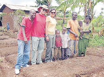 Tom and Malea Young pose with a family for whom the couple built a permagarden.