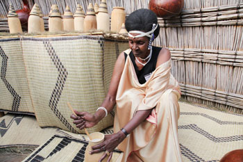 A woman demonstrating the process of making butter from milk  (File Photo)