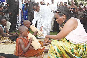 Agriculture Minister, Dr. Agnes Kalibata,feeding milk to a child at the launch of Nyanza Meseum (J. Mbanda)