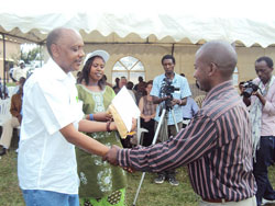 Dr.Theogene Rutagwenda awarding the best farmer a certifacate during the ceremony (Photo D. Ngabonziza)