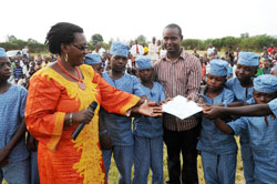  Kicukiro District Vice Mayor Florence Uwayisaba awards a certificate of appreciation to Emmanuel Semuhutu for his support to orphans. (Photo J Mbanda)