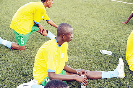 DOWN AND OUT; Defender Faustin Usengimana, seen here stretching in training, has been ruled out of action for four weeks with a knee injury. (File photo)