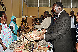 Minister of Trade and Industry Francois Kanimba admiring handcraft products at the  Handcraft Excellence Award Competition Expo which began Tuesday (File Photo)