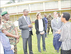 Rose Mukankomeje (R) chats with Gen. James Kabarebe (Third Left) as facilitators look on during the closing of the Environmental Security workshop in Musanze 