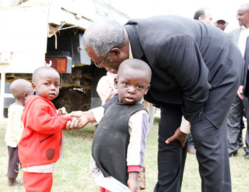 Disaster Management and Refugee Affairs Minister Marcel Gatsinzi talking to children of  returnees (Photo T.Kisambira