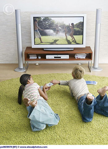 Two young kids fighting over the television remote