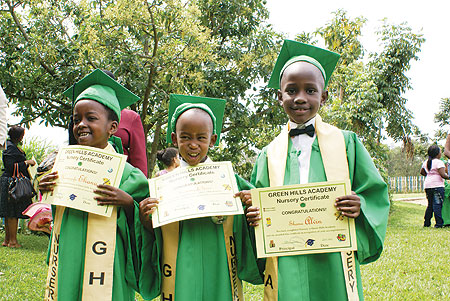 Children happily display their certificates.