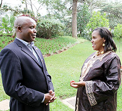 The Executive Secretary of IBUKA, Janvier Forongo,  (R) chats with Maggie Mutesi Mugisha of Gates ministries at Serena hotel, yesterday (Photo T.Kisambira)
