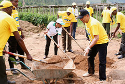 MTN's Khaled Mikkawi (in black cap) and DG of REMA, Dr Rose Mukankomeje participate in the preparation of a nursery bed in Rulindo District. (Courtesy photo)