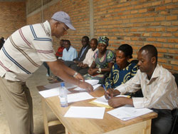 Head of USADF, Geofrey Kayigi (in cap),  hands over a prize to James Karangwa of COPRORIZ Ntende (Photo.D Ngabonziza)