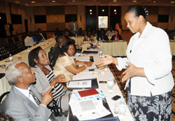 Chief Gender Monitor Oda Gasinzigwa (R) talks to some participants of the meeting on  GMO strategic plan. (Photo J Mbanda)
