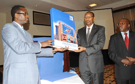 L-R;Bank of Kigali MD, James Gatera, Finance Minister, John Rwangombwa, and the Head of Capital Markets Advisory Council, Robert Mathu, unveil the BK Prospectus. (Photo/J Mbanda)