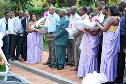 Minister of Disaster preparedness and Refugees Marcel Gatsinzi (C) leads employees from his Ministry to pay tribute to Genocide victims at Kigali Memorial Centre. (Courtesy Photo)