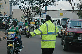 A Police man directs traffic during the Road Safety Week