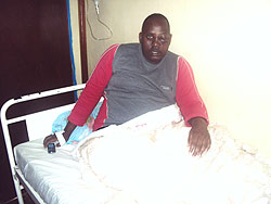 Innocent Rutabingwa's left eye cannot open yet as he seats on his hospital bed in Gahini hospital (Photo S. Rwembeho)