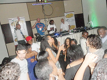 DJ Kaytrixx (2nd right in the extreme  background) spins the wheels of steel .