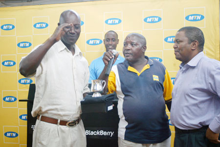 WINNER'S SMILE; Joseph Semwaga  (Left) receives a trophy after winning a past tournament. The golfer reigned supreme in yesterday's Liberation Day tournament. (File Photo)