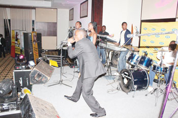 Tom Close performing with a live band.