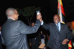  High Commissioner Frank Mugambage (L) makes a toast with Ugandan Foreign Affairs State Minister Asuman Kiyingi during the liberation day celebrations in Kampala (Photo G Muramira)