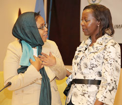 Hon Zahra Samantar( L) the Somalian Minister for Women Affairs and Human Rights chats with Louise Mushikiwabo of Foreign Affairs at the meeting, yesterday. (Photo T.Kisambira)