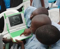 Primary school pupils using a laptop; MINEDUC has installed security systems in the laptops.(File Photo )