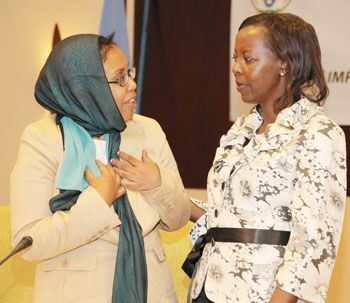 Hon Zahra Samantar( L) the Minister for Women Affairs and Human Rights of Somalia chatting with, Louise Mushikiwabo Minister of Foreign Affairs (By T. Kisambira)