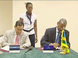  Finance Minister John Rwangombwa signs the agreement as the BADEA boss Abdelaziz Khelef looks on (Courtesy Photo)