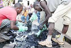  Residents sort the remains of the Genocide victims exhumed from Kigali's Hotel Tech (Photo T.Kisambira)